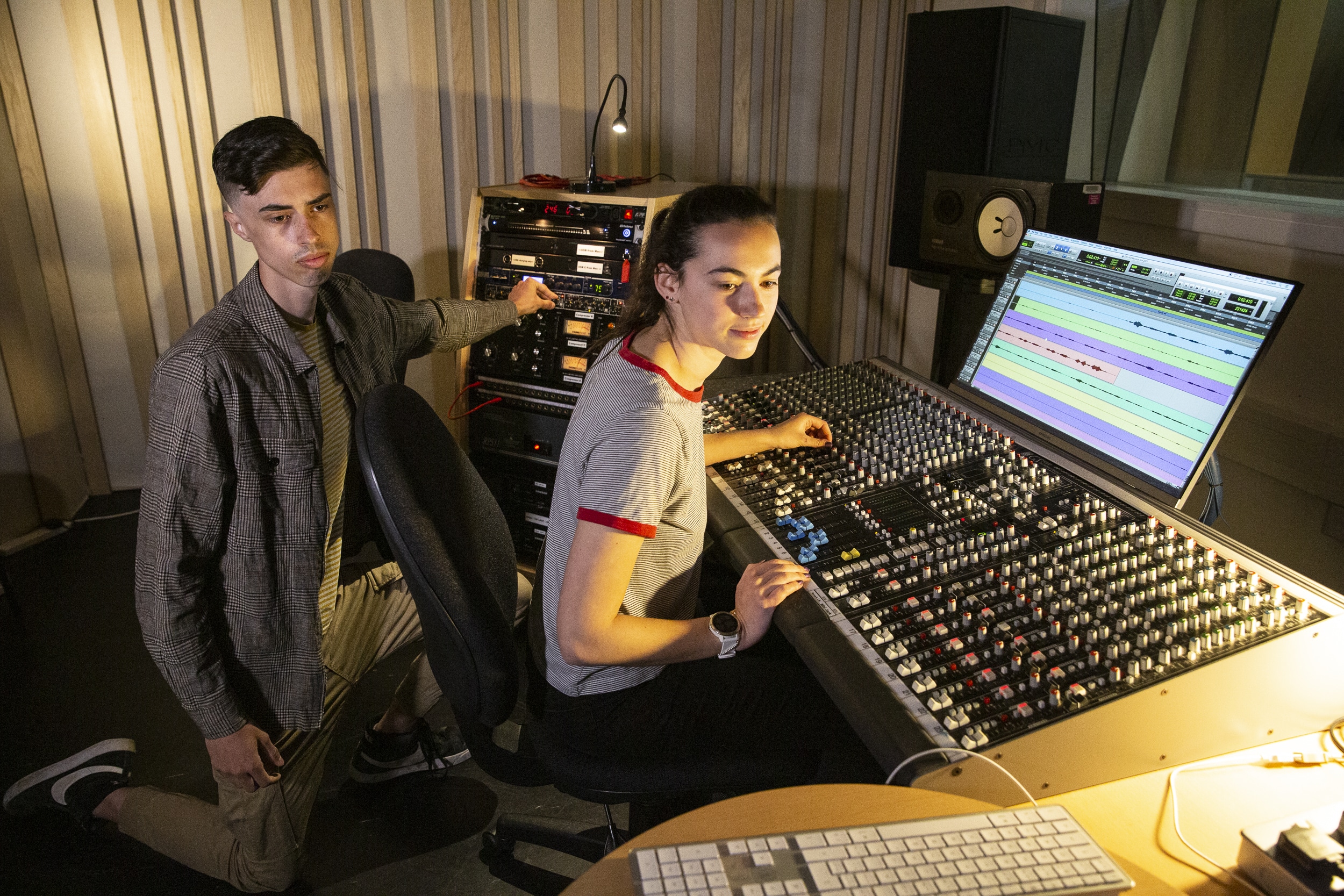 Two Rose Bruford College Audio Production students at a sound desk